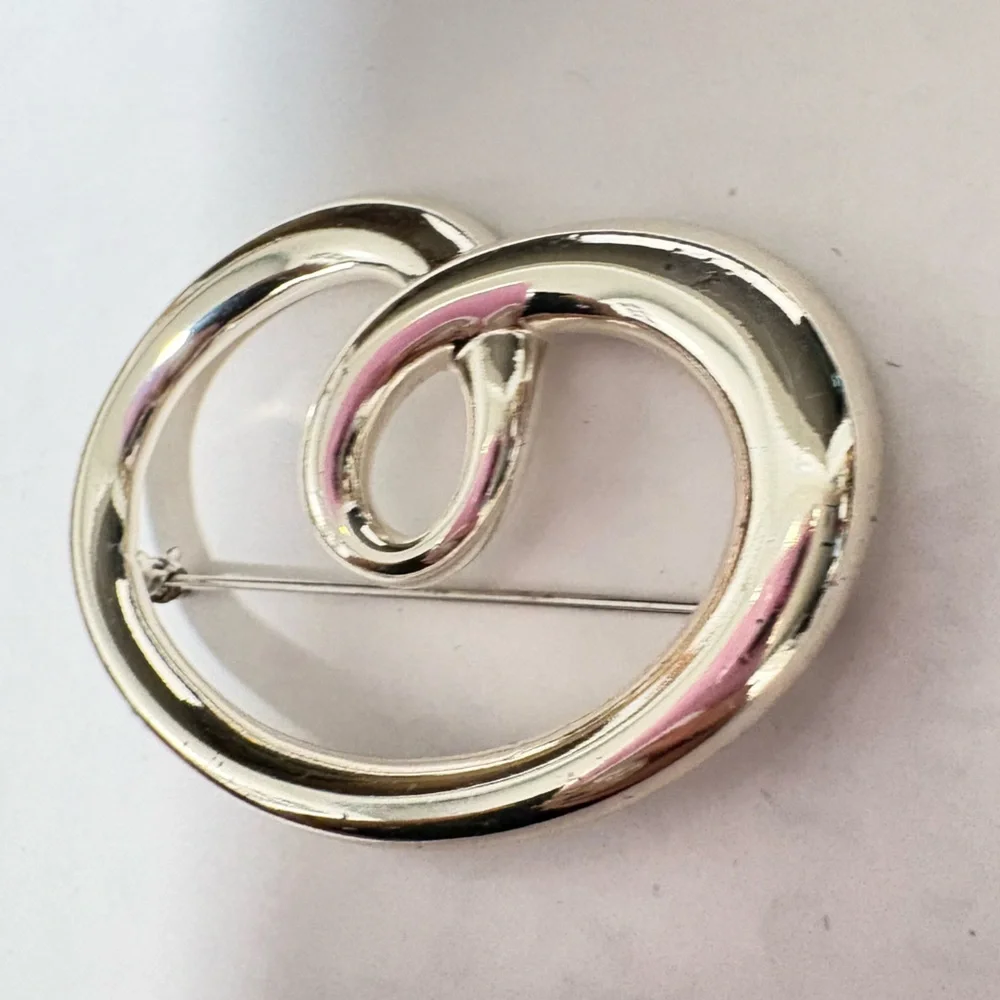 Vintage sign, Monet Silvertone heart shaped swirl Brooch